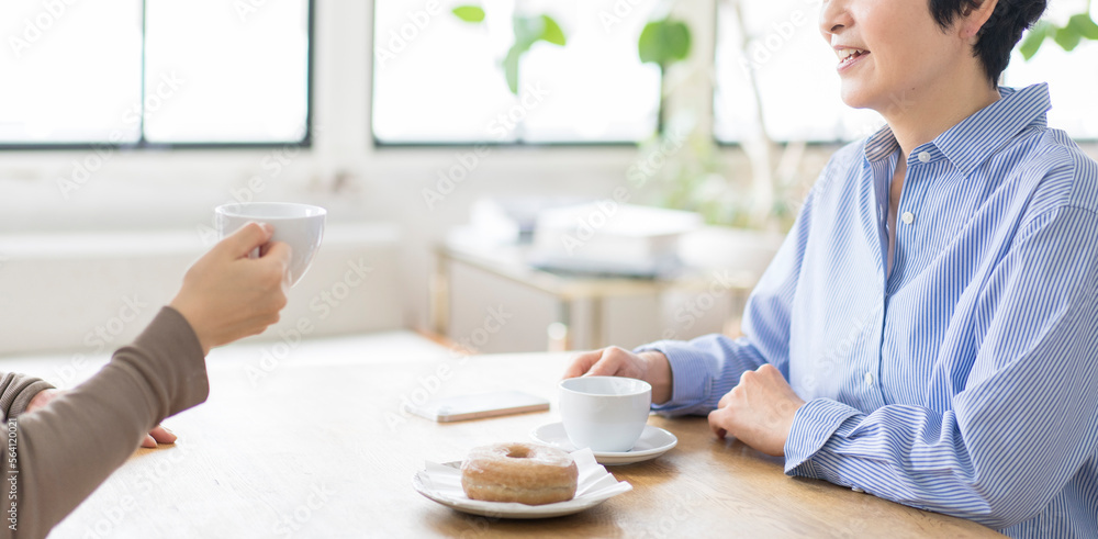カフェで同僚とお茶を楽しむ女性 カフェで同僚とお茶を楽しむ女性