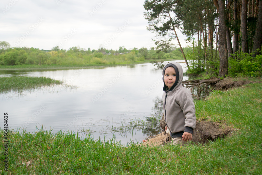 Children walk on the shore of the lake. Boys in nature. Children walk on the shore of the lake. Boys in nature.