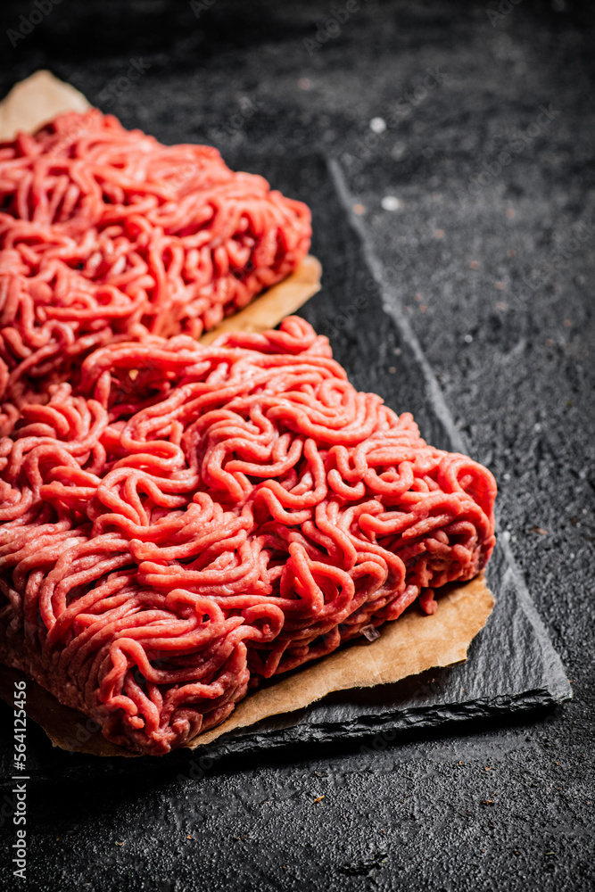 Raw minced meat on a stone board. Raw minced meat on a stone board.