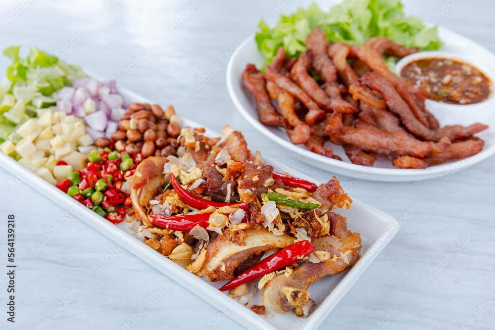 Fototapeta premium Fried Sun-Dried Pork and Fermented Pork Delicious hands on the table
