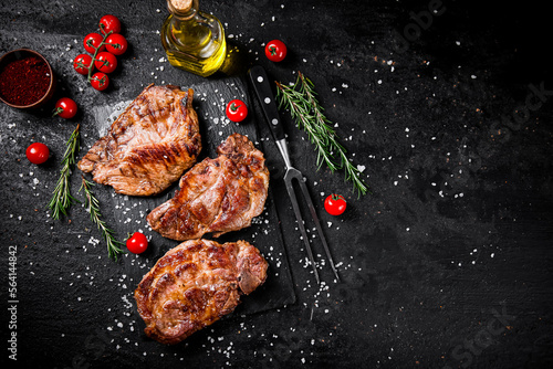 Grilled pork steak with cherry tomatoes and rosemary. 