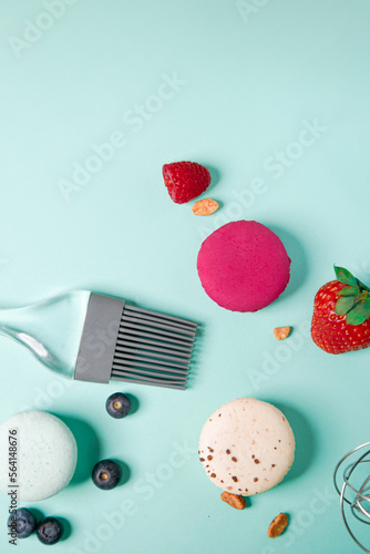 Close-up of macaroons of different colors in blue background. Culinary and tsuking concept. Tasti tsolurful matzaroons. Pastel color. food deconstruction.. photo