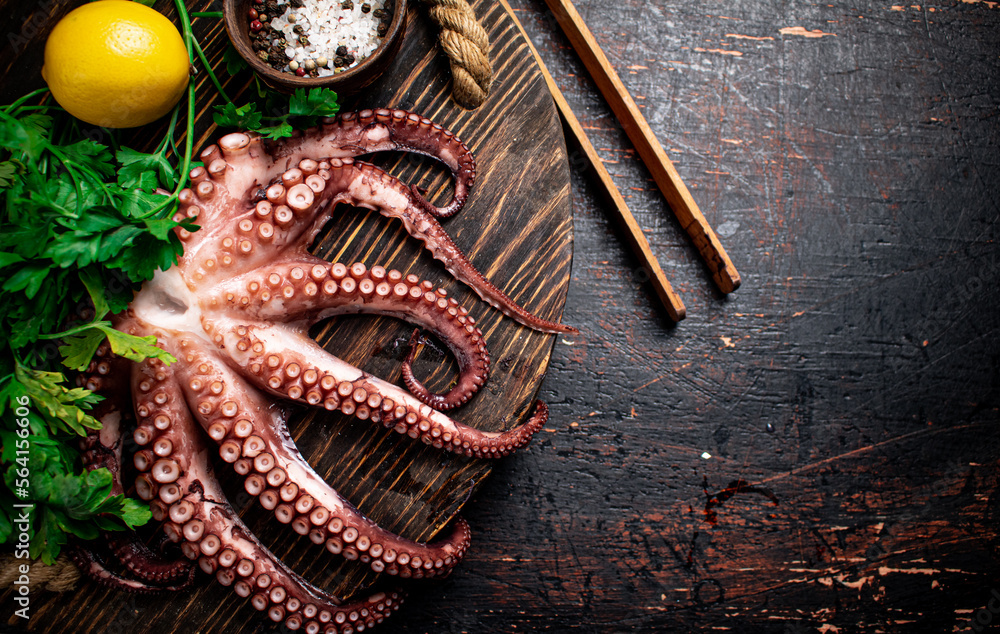 Fototapeta premium Fresh octopus on a wooden tray. 