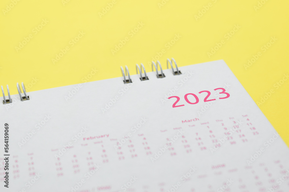 white calendar 2023 on yellow background white calendar 2023 on yellow background