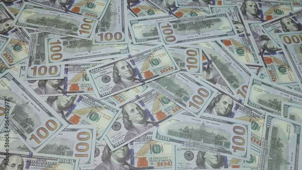 One hundred dollars are scattered on the table. American bills. A lot of money fills the simple people in the picture. One hundred dollars are scattered on the table. American bills. A lot of money fills the simple people in the picture.