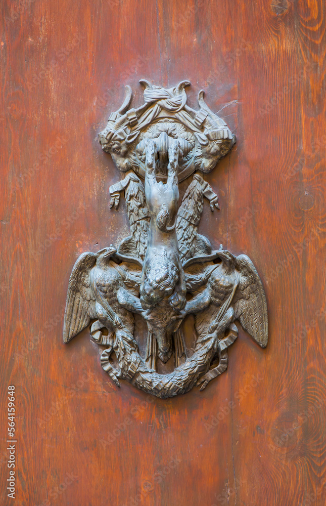 Door handle like antique head on the entrance of a house - Bologna, Italy Door handle like antique head on the entrance of a house - Bologna, Italy