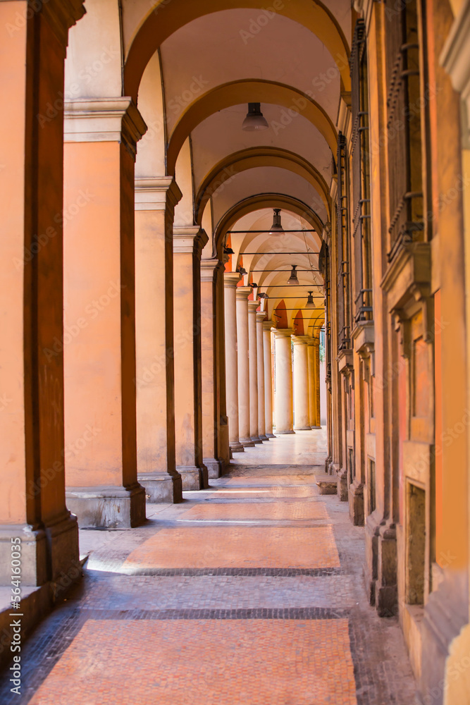 Narrow city street view traditional architectural features in Bologna, Italy