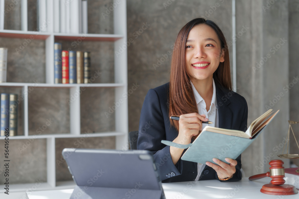 Attractive young female asia lawyer working with contract papers and online consulting with the new law of real estate business. Law, legal services, advice, Justice, legislation Attractive young female asia lawyer working with contract papers and online consulting with the new law of real estate business. Law, legal services, advice, Justice, legislation