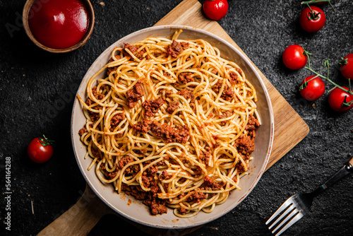 Delicious spaghetti bolognese in a bowl with cherry tomatoes. 