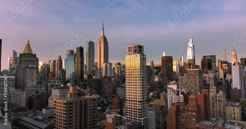 Aerial shot of NYC rising above buildings in Midtown Manhattan Skyline during beautiful sunrise sky