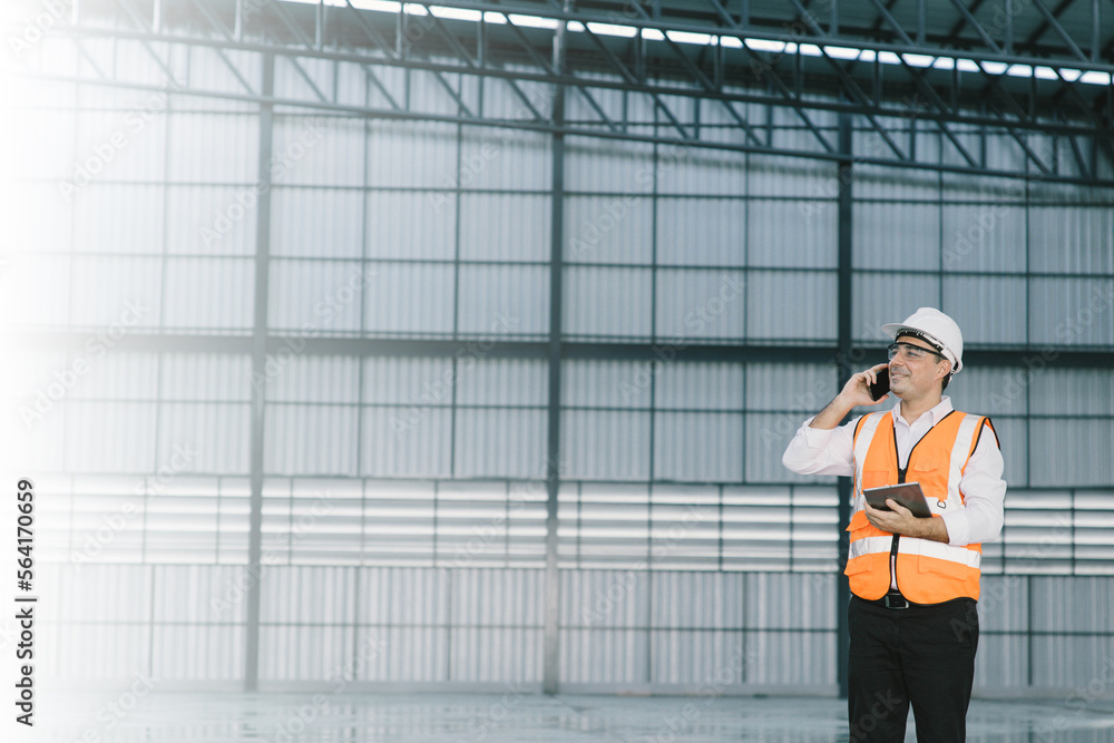 warehouse manager with smartphone and radio communication his worker working in background in warehouse distribution center environment. Business warehouse inventory,contruction warehouse warehouse manager with smartphone and radio communication his worker working in background in warehouse distribution center environment. Business warehouse inventory,contruction warehouse