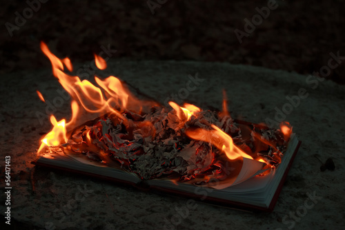 A burning book on the ground