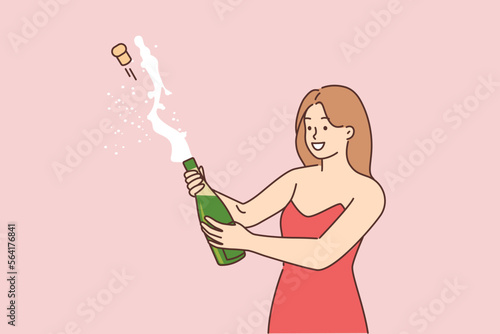 Young girl opening a bottle of champagne