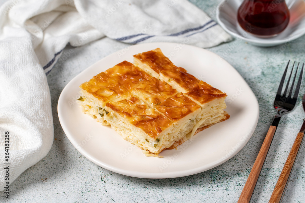Turkish Su Boregi or Tabla borek with cheese. Turkish Patty on stone background. Close up Turkish Su Boregi or Tabla borek with cheese. Turkish Patty on stone background. Close up