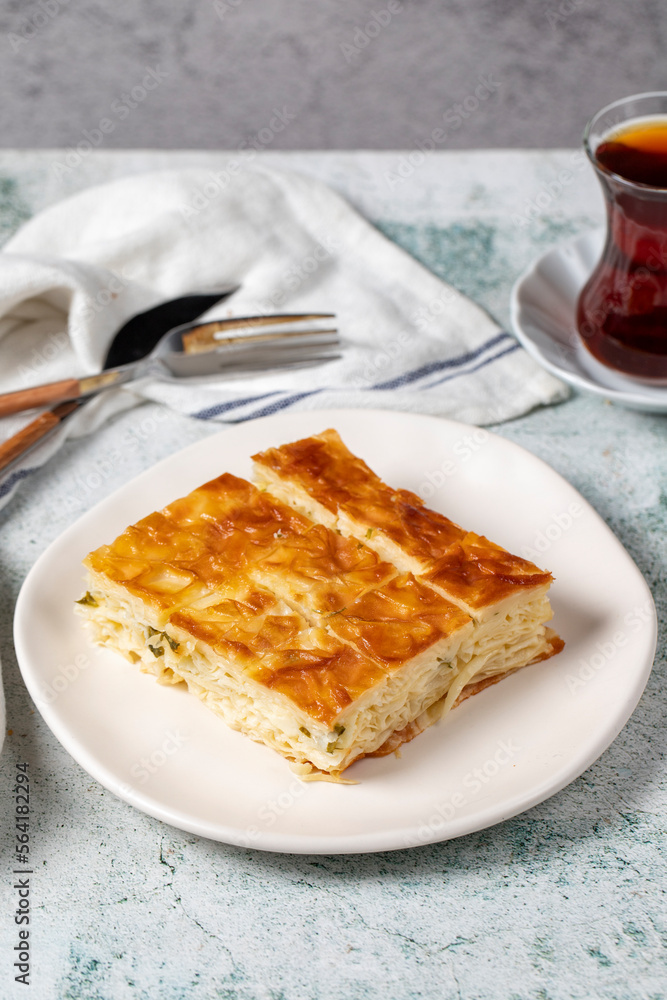 Turkish Su Boregi or Tabla borek with cheese. Turkish Patty on stone background. Close up Turkish Su Boregi or Tabla borek with cheese. Turkish Patty on stone background. Close up