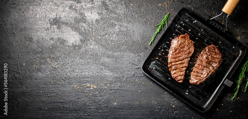 Delicious grilled steak in a frying pan. 