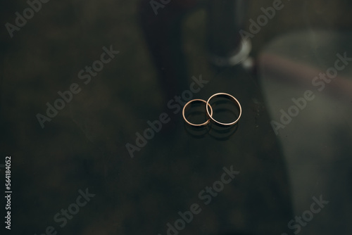 wedding rings on a table on a dark background