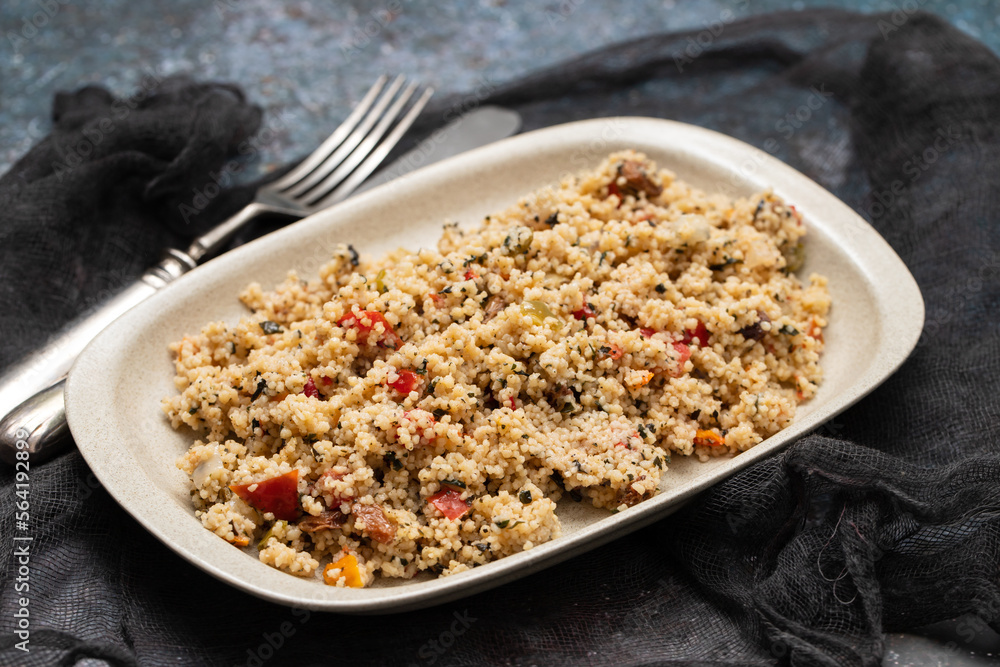 Couscous with vegetables in a dish with fork Couscous with vegetables in a dish with fork