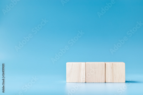 Fototapeta Naklejka Na Ścianę i Meble -  three blank wooden blocks on blue background.