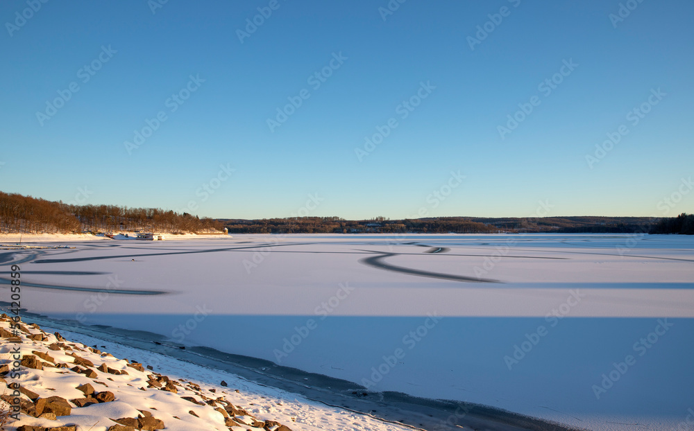 Scenic View Of Frozen Landscape Against Blue Sky