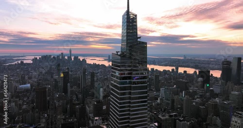 NYC Sunset Skyline Aerial of Vanderbilt One Empire State World Trade Center buildings in background with sun reflecting on Hudson river