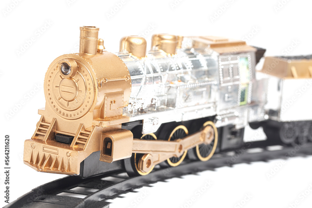 toy train with freight car trolley on railway tracks, isolated on white background, children's railway with steam locomotives, battery powered train.