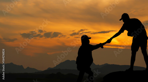 People helping each other to walk up the mountain at sunrise lend a helping hand