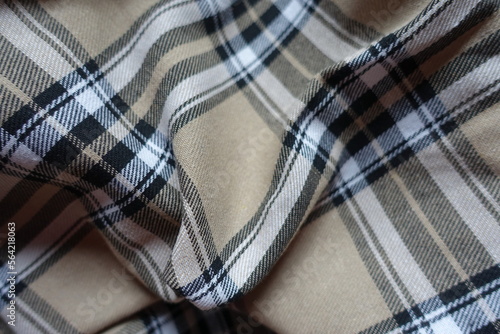 Rumpled beige, black and white cotton flannel tartan fabric