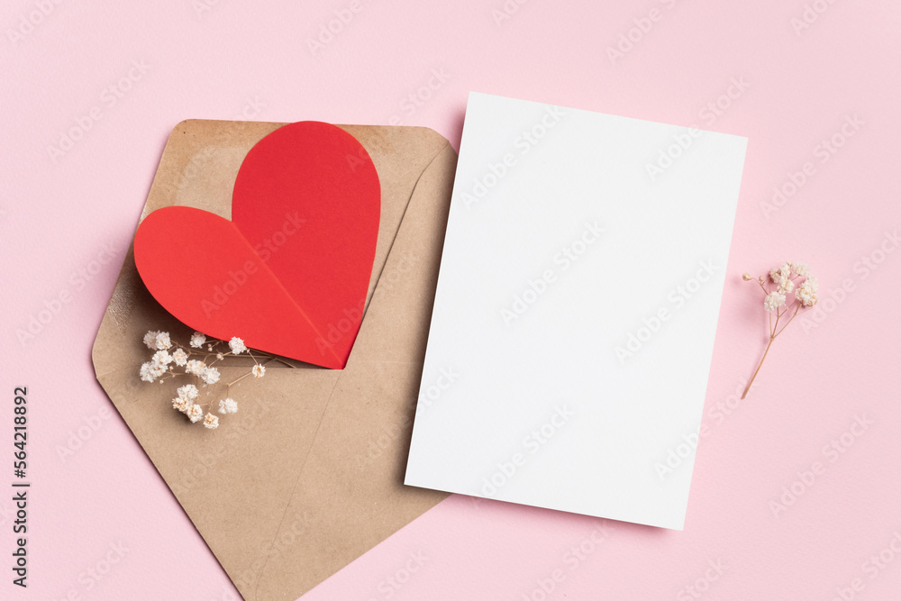 Valentines day card mockup and red hearts in envelope on pink paper background