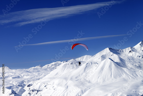 Sky gliding in snowy mountains at nice sun day
