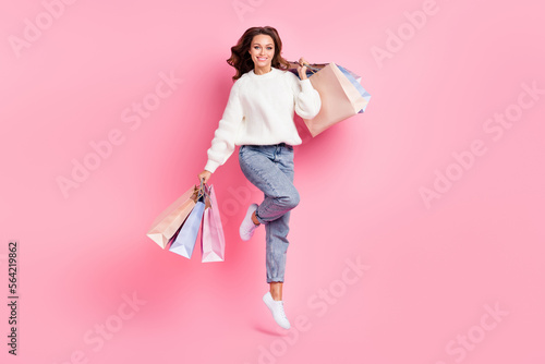 Full length photo of pretty sweet woman dressed white pullover jumping high rising bargains isolated pink color background