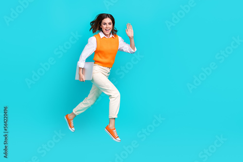 Full length size photo of young funky girl wear shirt formal uniform shake palm hello hold laptop coworking promo isolated on blue color background