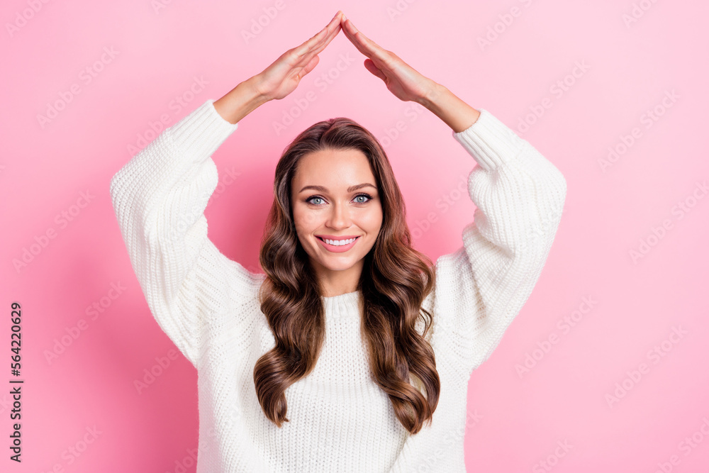 Photo of cheerful lovely person beaming smile arms demonstrate make roof gesture above head isolated on pink color background