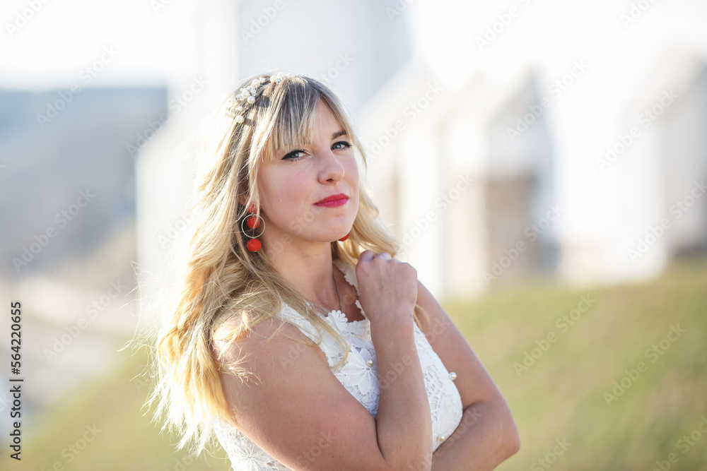 Outdoor close up portrait beautiful blonde girl with youth and skin care attractive looking at camera in white dress. Light key Outdoor close up portrait beautiful blonde girl with youth and skin care attractive looking at camera in white dress. Light key