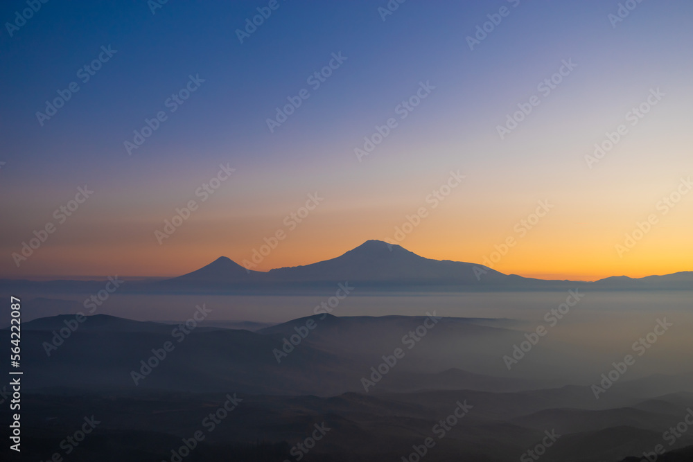 Mount Ararat at dramatic sunset on a foggy winter day