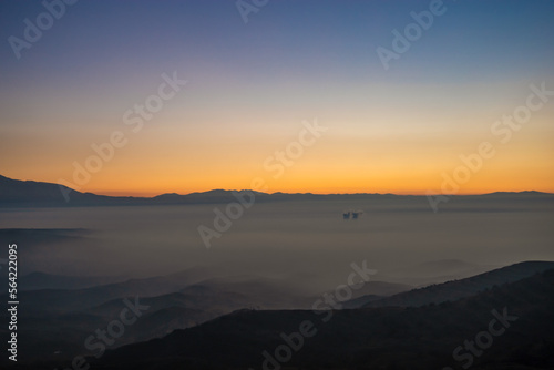 Colorful sunset shot in the mountains above the clouds on a winter day