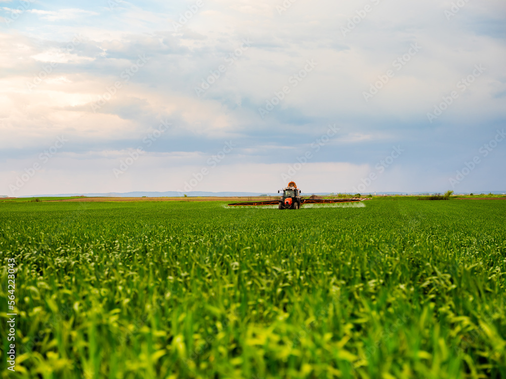 Scientific crop protection with tractor-applied herbicides, pesticides, and fungicides, farmer ensuring plant health and yield Scientific crop protection with tractor-applied herbicides, pesticides, and fungicides, farmer ensuring plant health and yield