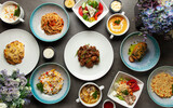 Assortment of dishes. Many dishes.  Salads, soups, side dishes