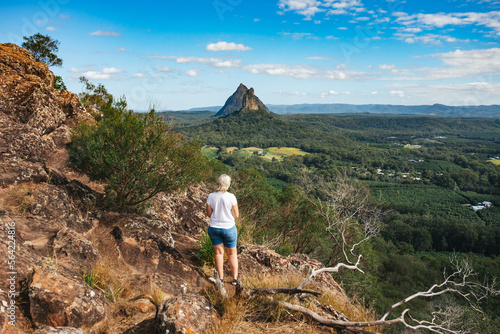 Woman looking out at the view from Mt Ngungun in the Glass House Mountains on the Sunshine Coast, Australia photo