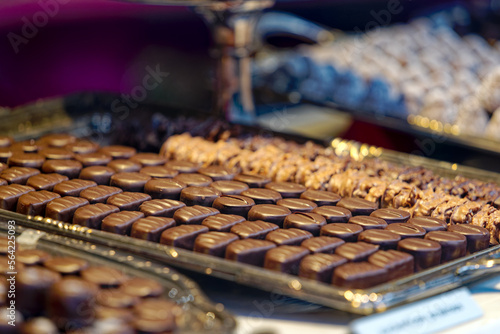 Close-up of different kinds of brown Swiss pralines on tablet at shop window. Photo taken January 13th, 2023, Zurich, Switzerland.