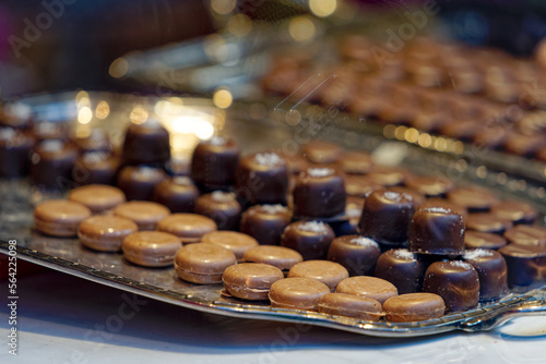 Close-up of different kinds of brown Swiss pralines on tablet at shop window. Photo taken January 13th  2023  Zurich  Switzerland.