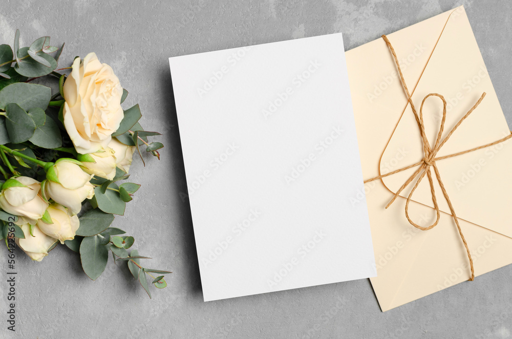 Wedding invitation card mockup with envelope and fresh roses flowers, card with copy space Wedding invitation card mockup with envelope and fresh roses flowers, card with copy space