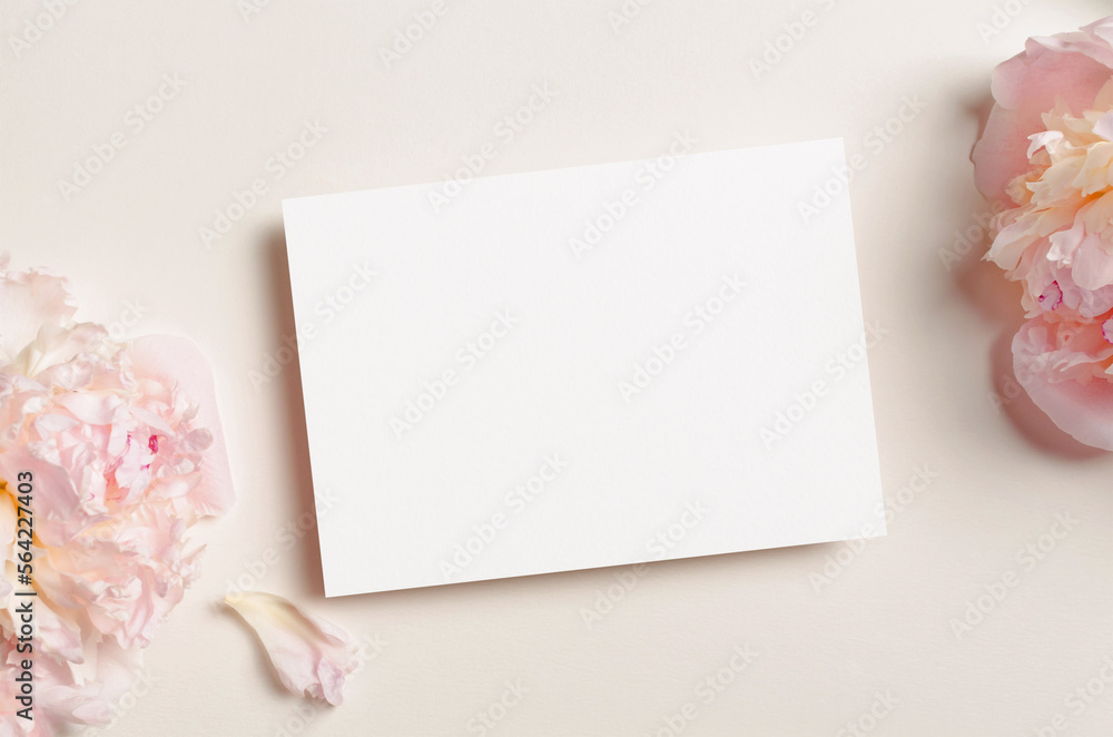 Blank invitation or greeting card mockup with fresh peony flowers Blank invitation or greeting card mockup with fresh peony flowers