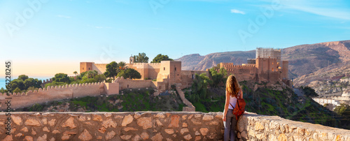 Woman tourist enjoying panorama view of Alcazaba,  Almeria in Spain