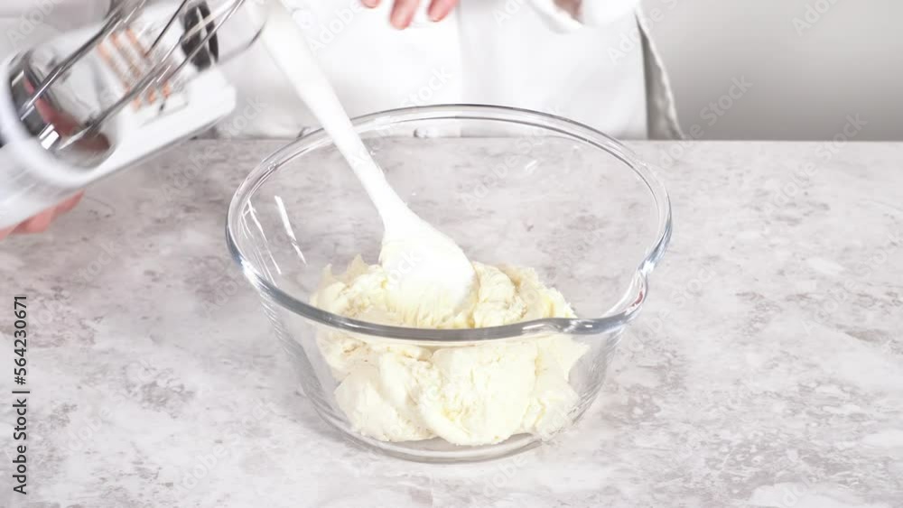 Time lapse. Mixing in pink food coloring into a vanilla buttercream frosting for decorating funfettti bundt cake. Time lapse. Mixing in pink food coloring into a vanilla buttercream frosting for decorating funfettti bundt cake.