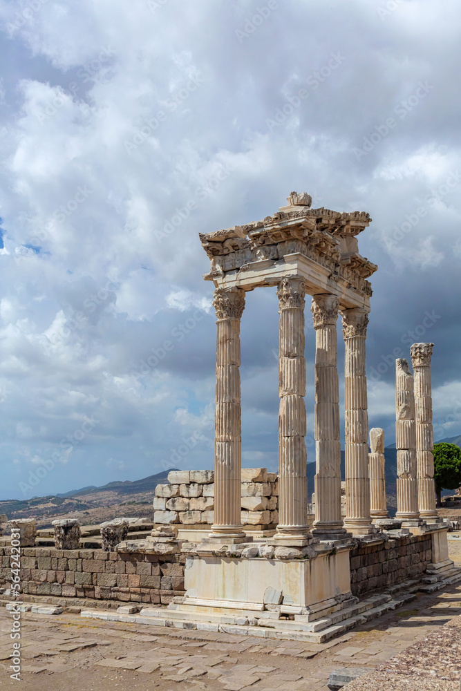 The ruined Temple of Trajan in Pergamon Ancient City. Corinthian order. Dramatic sky at background. Vertical shot, copy space. History, art or architecture concept. Bergama, Turkey