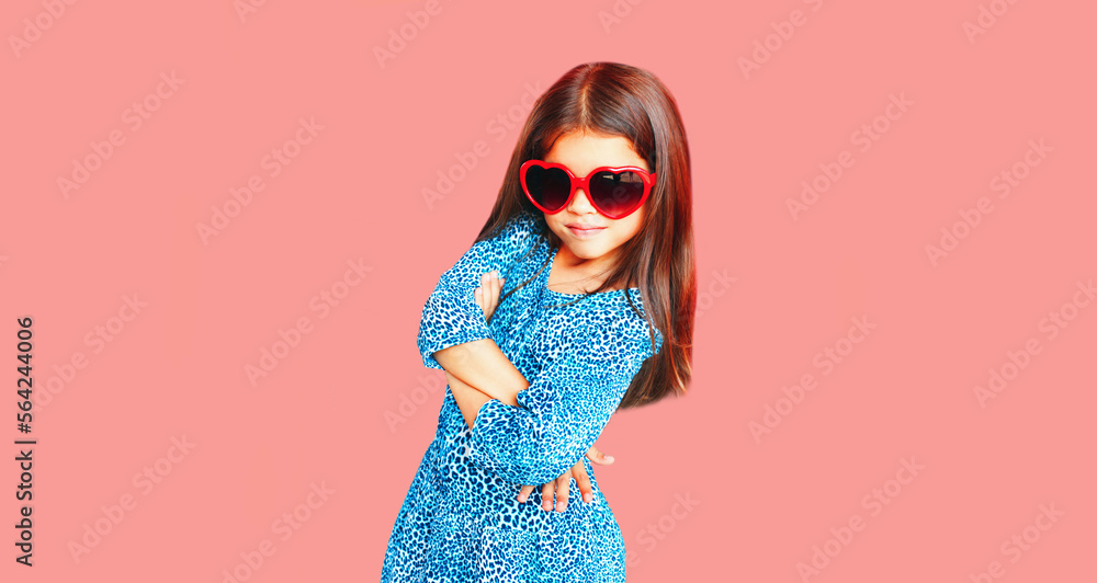 Portrait of beautiful little girl child wearing blue dress on pink background Portrait of beautiful little girl child wearing blue dress on pink background