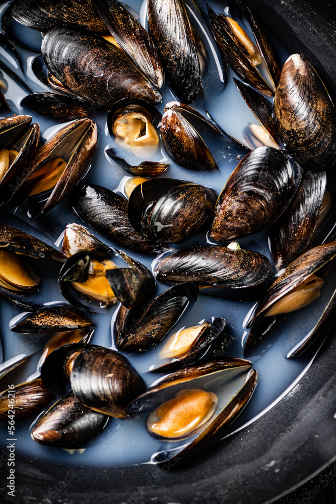 Delicious mussels are boiled in a pot of water. Delicious mussels are boiled in a pot of water.