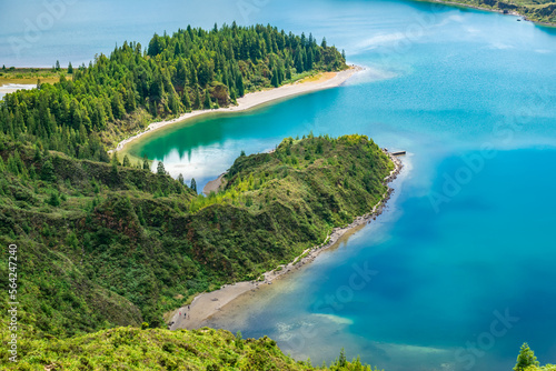 Crater hill with vegetation and cryptomerias and turquoise blue water of Lagoa do Fogo, São Miguel - Azores PORTUGAL