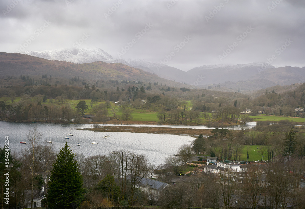 Clappersgate and Waterhead on the shore of Lake Windermere with the summit of Wetherlam and Wynrose pass in the distance on a cold winters morning in the Lake District Cumbrian Mountains, England, UK.
